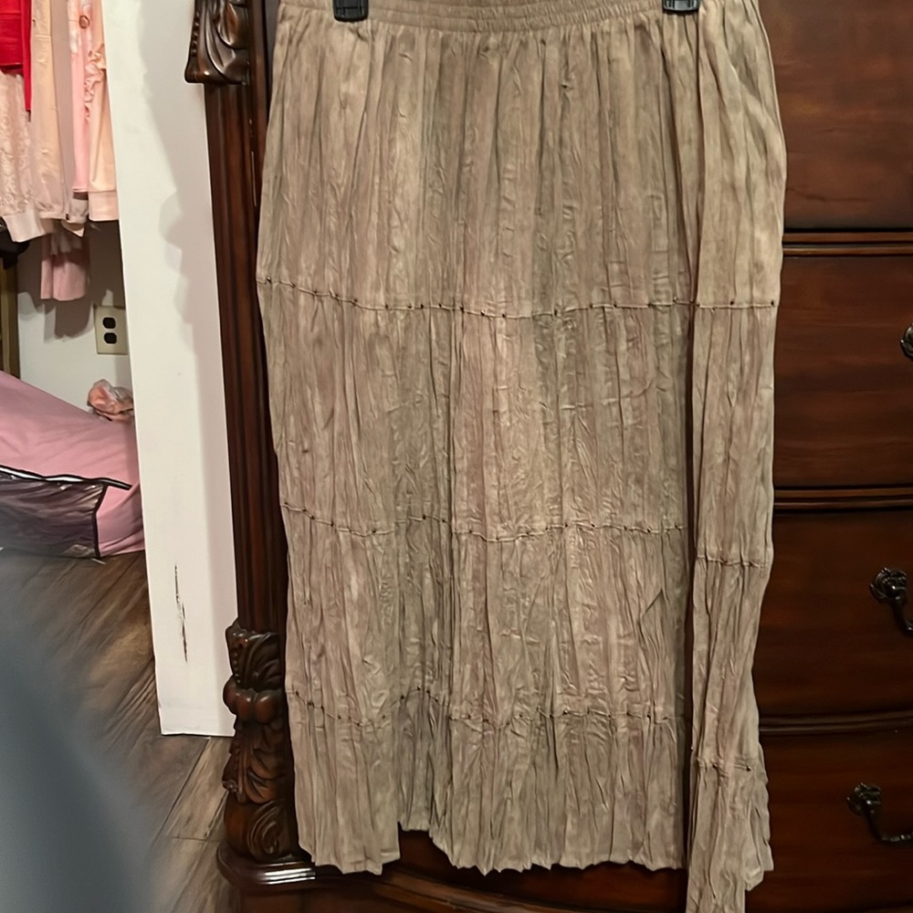 Women skirt midi length kind of pleated but not much has beads across every row